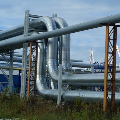 Industrial pipes forming loops and bends in an outdoor setting.