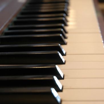 Close-up of piano keys showing black and white keys in a row.