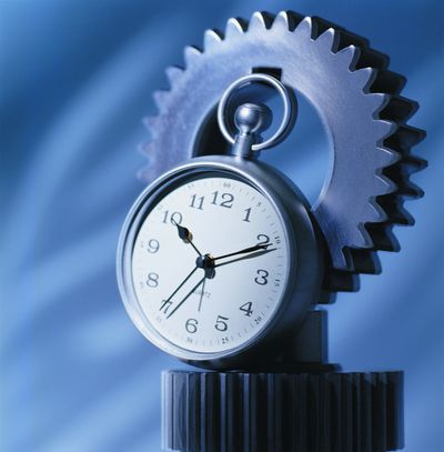 A pocket watch integrated with mechanical gears against a blue background.