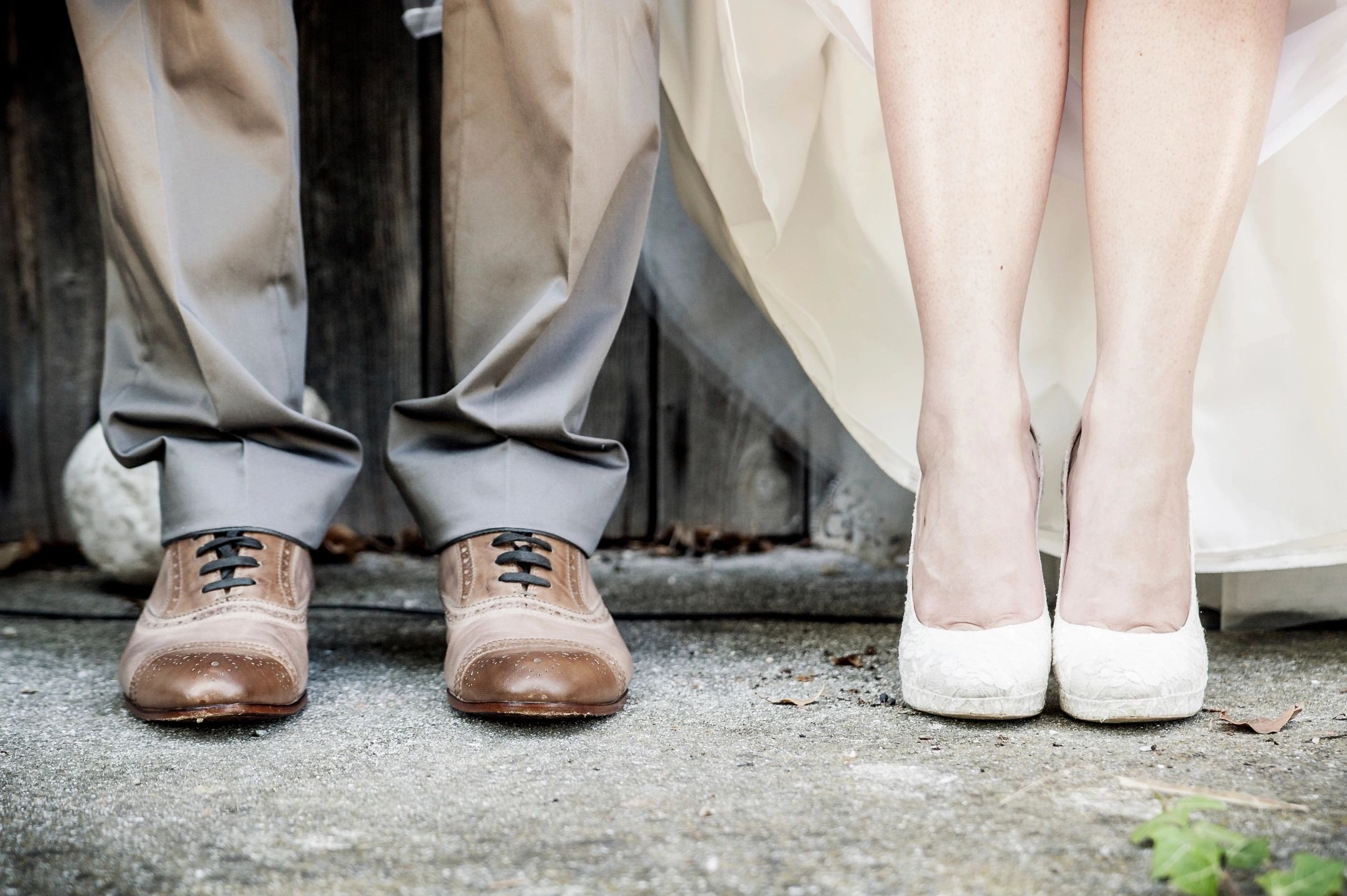 Close up of bride and groom wearing shoes