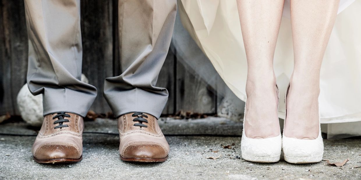 Close-up of a couple's feet on a stone path