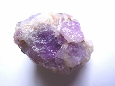 Close-up of a raw amethyst crystal with purple hues.