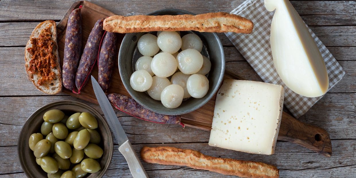 Mixed food with cheese, olives, charcuterie and bread