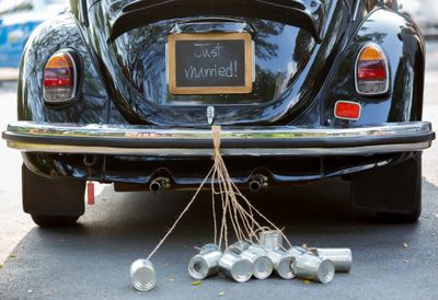 A black car with a Just Married sign