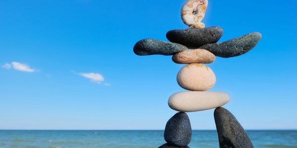 Different coloured stone stacked together to make shape of a person