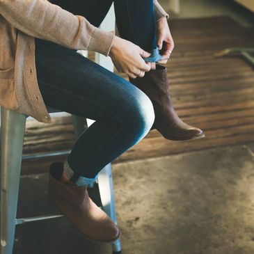 person sitting on a stool