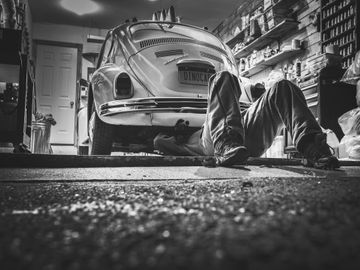 Man working on vw beetle.