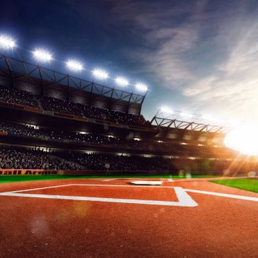 Empty baseball field at sunset in a stadium.