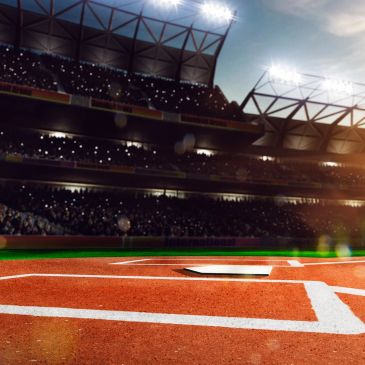 View of home plate on a baseball field under stadium lights.