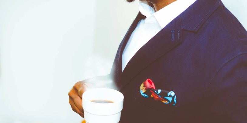 Man holding a cup of hot coffee