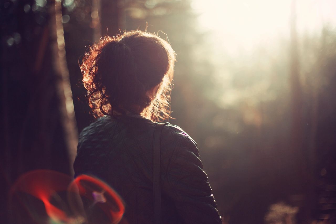 A lady takes a walk and watched the sunset as she thinks deeply about how to overcome a conflict.