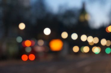 Blurred city lights creating a bokeh effect at dusk.