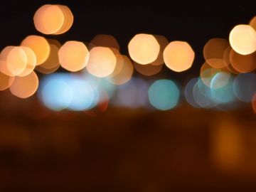 Blurred colorful city lights creating a bokeh effect at night.
