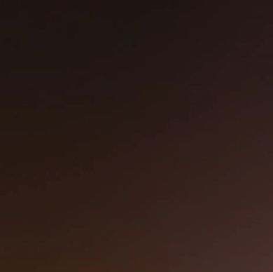 A blurry purple and brown light effect with soft edges.