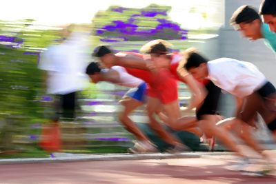 Blurred image of boys sprinting at the start line in a race.