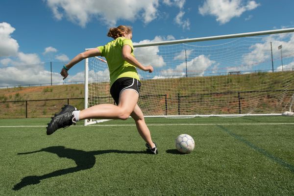 Soccer player kicking goal