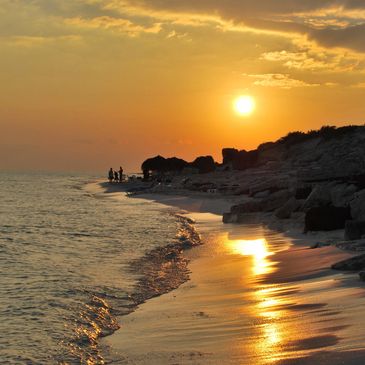 Ocean view with sun reflecting the sand.