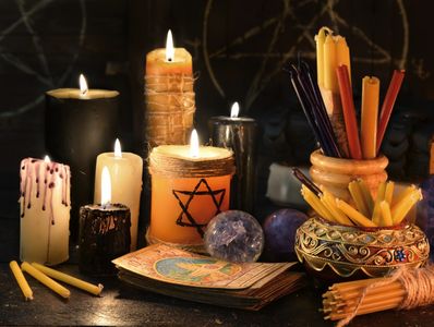 A mystical altar with lit candles, tarot cards, and crystals.