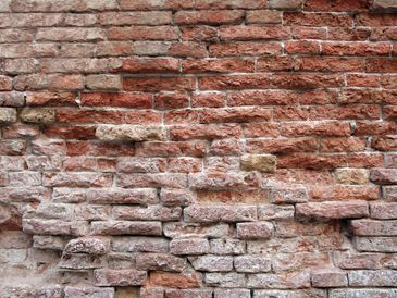 Before-A-wall-of-bricks-needing repair-1-crumbling brick-2-missing-brick-faces-3- exposed-brick.
