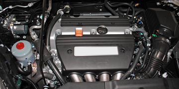 Car engine with visible intake manifold and oil cap.
