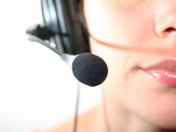 Close-up of a person wearing a headset with a microphone.