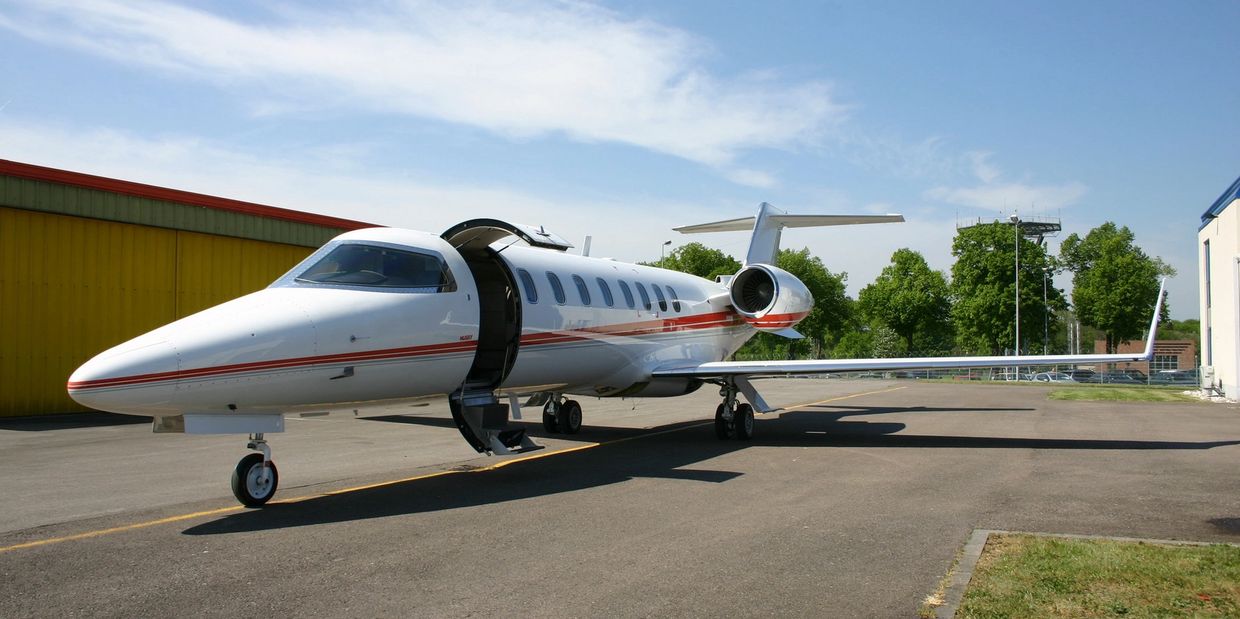 Luxury private jet parked in the airport with the door open