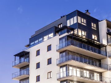Modern apartment building at dusk.