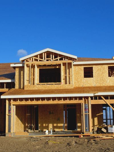 A house under construction with wood framing being built.