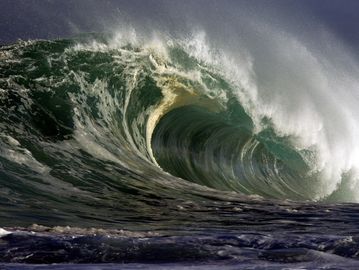 A powerful ocean wave curling and crashing.