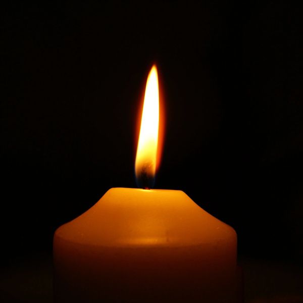 a candle with soft white flame