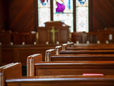 Empty wooden pews inside a church.