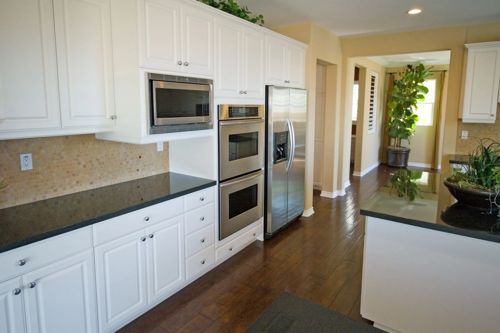 Kitchen with side-by-side stainless-steel fridge, wall oven and built in microwave