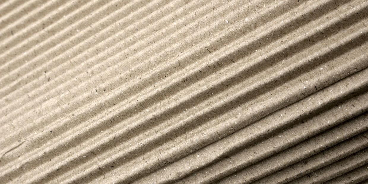 Close-up of corrugated cardboard texture with diagonal ridges.