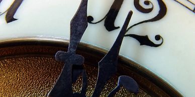 A close up picture of a clock going to struck 12