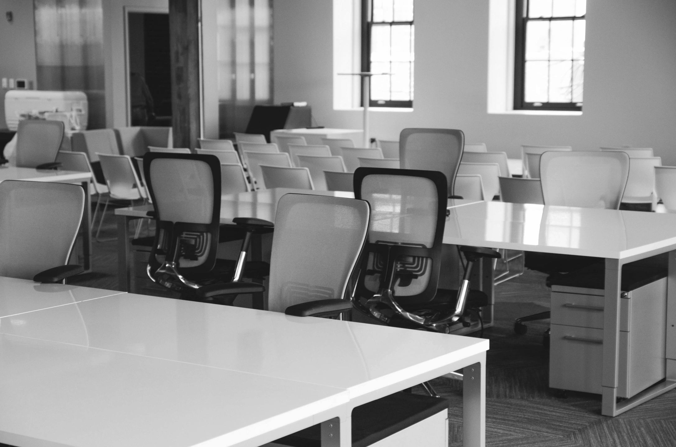 Empty modern office with ergonomic chairs and desks.