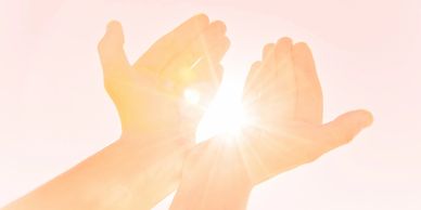 Hands radiating Reiki energy