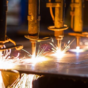 Metal cutting with sparks flying from machinery.