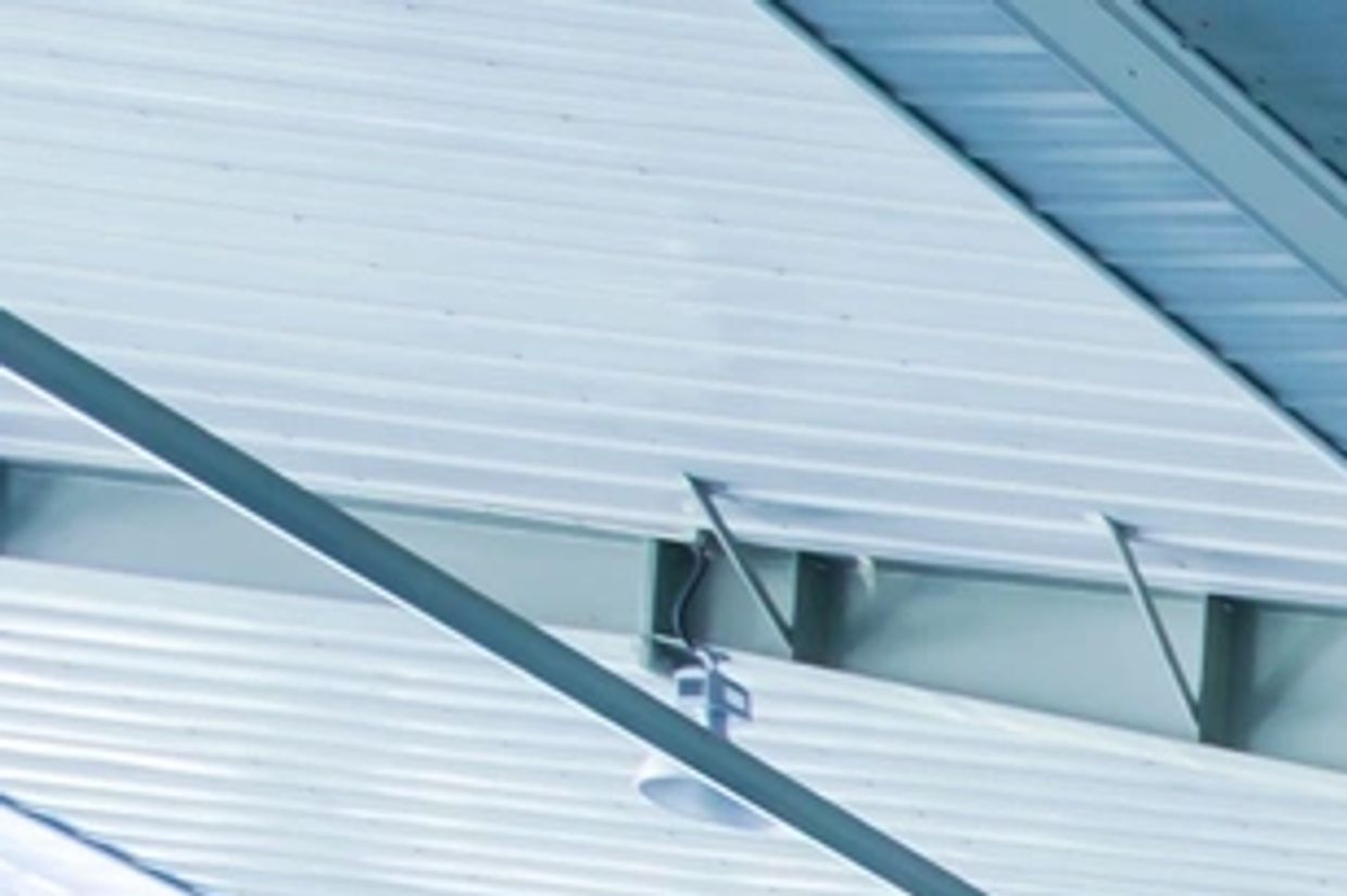 Ceiling with metal panels and structural beams.