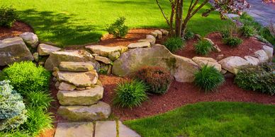 landscaping job with brown bark and rock steps