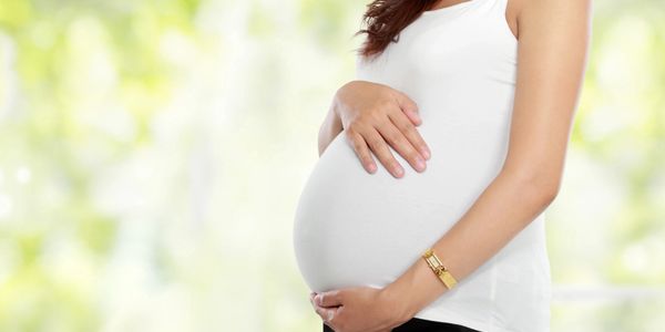 Pregnant women cradling bump