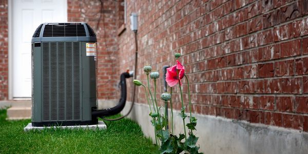 A residential condensing unit outside of a home