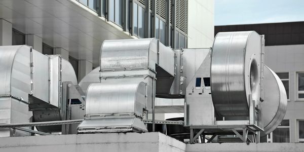 Building rooftop with commercial HVAC units . 