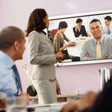 Professionals engaged in a video conference meeting.