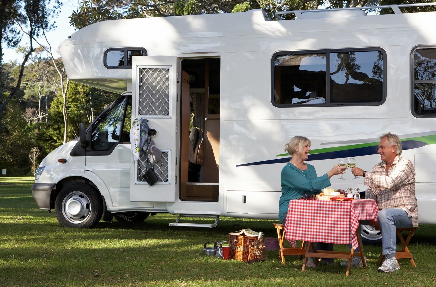 People enjoying their time camping with their RV.