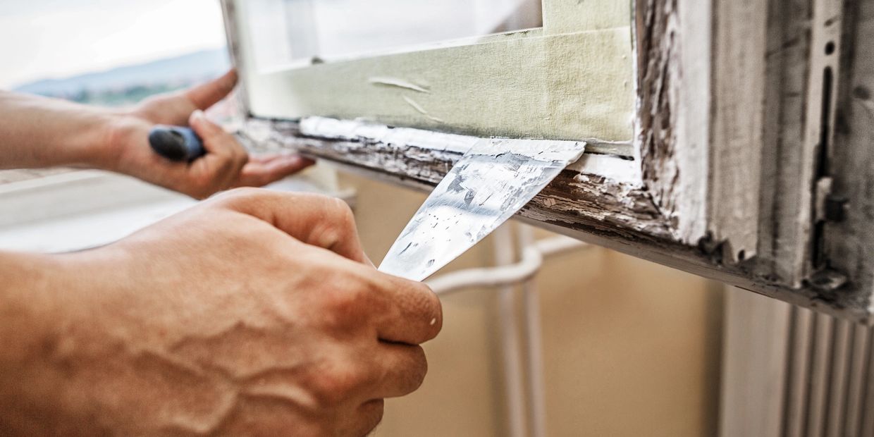 A Person Repairing Rotten Wood Frame