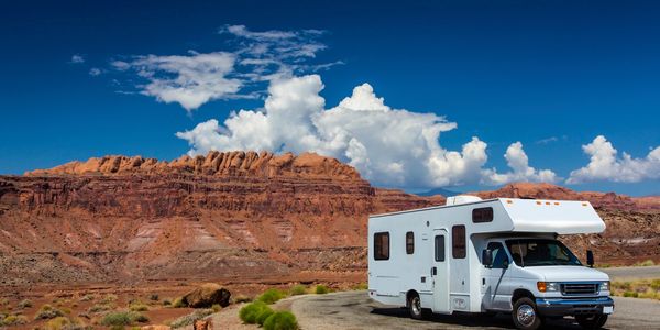 an RV parked near red rocks in the southwest United States