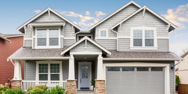 White and gray two story house on sunny day