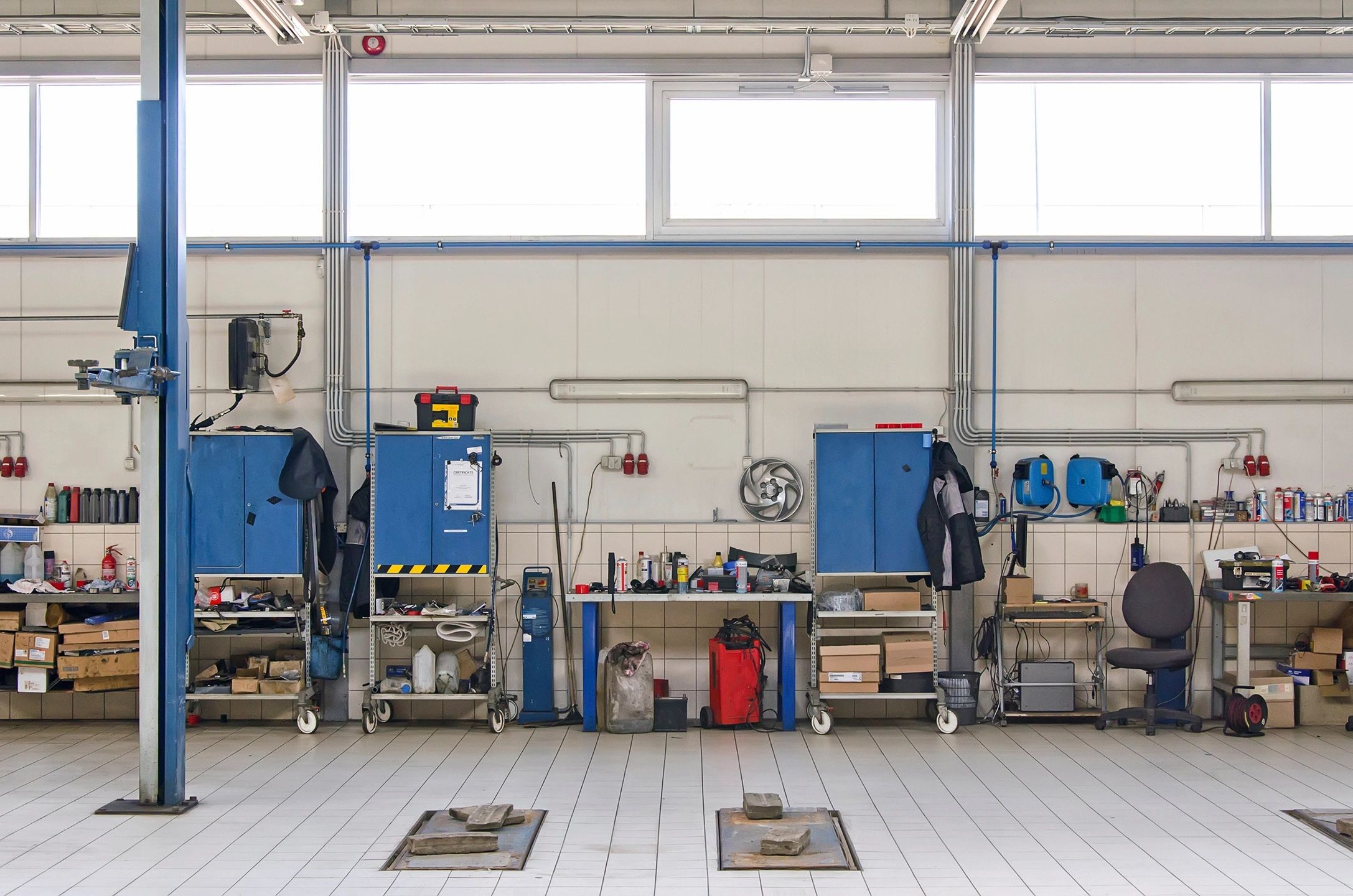 Organized automotive workshop with tools and equipment.