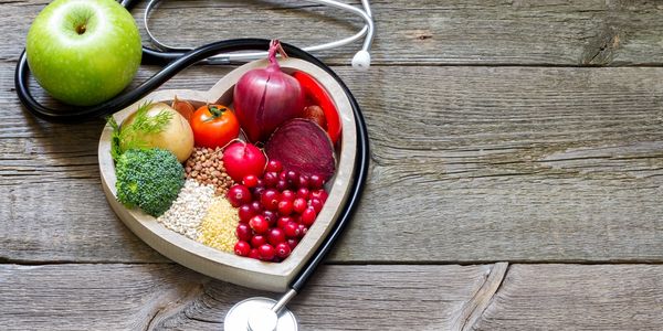 Apple with medical equipment on wooden table. Natural health.