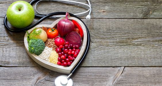 a heart-shaped plate with healthy ingredients in it